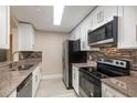 Modern kitchen with stainless steel appliances, white cabinets, and granite countertops at 3960 Southpointe Dr # 501, Orlando, FL 32822
