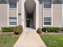 Exterior entrance to condo building with clean walkway, trimmed bushes, and clear building number at 4403 Hector Ct # 3, Orlando, FL 32822