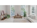 Bright living room featuring large windows, neutral decor, and stylish furnishings at 478 Water St, Kissimmee, FL 34747
