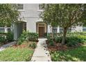 Well-maintained townhouse with landscaped walkway leading to an inviting front door at 5838 Cypress Hill Rd, Winter Garden, FL 34787