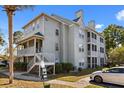 A lovely condominium exterior featuring multi-level balconies, neat landscaping, and designated parking spaces at 6178 Westgate Dr # 101, Orlando, FL 32835