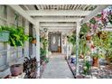 Picturesque front porch featuring hanging plants, colorful decorations and charming decor on the walkway to the front door at 623 Green Meadow Ave, Maitland, FL 32751