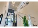 Bright foyer featuring an open staircase with Walt Disney decal, striking light fixture, and elegant zebra rug at 6301 Sand Skipper Rd, Orlando, FL 32821