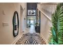 Inviting foyer features a zebra rug and staircase leading to the second floor at 6301 Sand Skipper Rd, Orlando, FL 32821
