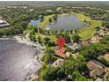 Beautiful aerial view of lakefront home and backyard pool, nestled near a golf course and other lakes at 709 Cricklewood Ter, Lake Mary, FL 32746
