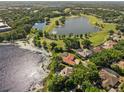 Beautiful aerial view of lakefront home and backyard pool, nestled near a golf course and other lakes at 709 Cricklewood Ter, Lake Mary, FL 32746