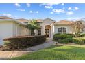 Inviting front entrance with red double doors and manicured landscaping at 7351 Spring Mountain Ln, Yalaha, FL 34797