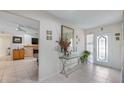 The foyer features tile flooring, a decorative mirror, and leads into a living space with a fireplace at 8444 Sandberry Blvd, Orlando, FL 32819