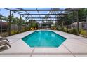 Backyard pool with screened-in enclosure and outdoor seating, creating an ideal space for relaxation and entertaining at 8444 Sandberry Blvd, Orlando, FL 32819