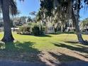 Well-maintained single story home with an expansive lawn and shade trees at 951 Cr 453, Lake Panasoffkee, FL 33538