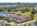 A beautiful two-story home with a terracotta roof adjacent to a golf course and a scenic pond at 971 Golden Bear Dr, Reunion, FL 34747