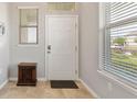 Bright entryway with tile flooring and a large window with view of the manicured yard at 10006 Quail Meadow Aly, Winter Garden, FL 34787