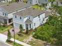 New two-story home featuring a brick driveway, landscaping, and a well-maintained lawn at 1096 Happy Forest Loop, Deland, FL 32720
