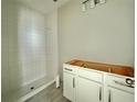 Bathroom featuring a new shower with white tile and a vanity with drawers at 1157 Basalt Ln, Sanford, FL 32771
