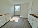 Bathroom featuring white cabinets, a shower, and a window with a view at 1157 Basalt Ln, Sanford, FL 32771