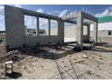 Image shows an unfinished garage with concrete block walls, structural supports and construction debris on the ground at 1157 Basalt Ln, Sanford, FL 32771