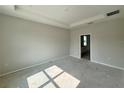A spacious bedroom features a tray ceiling, access to the Primary bathroom, and neutral paint at 1161 Basalt Ln, Sanford, FL 32771
