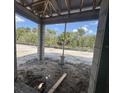 Unfinished lanai showing cinderblock columns with a view of the backyard and a black iron fence at 1161 Basalt Ln, Sanford, FL 32771