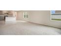 Spacious living room featuring neutral-toned carpet, natural light, and an open layout at 1221 August Sky Dr, Deltona, FL 32738