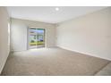 Bright and airy living room with sliding glass doors leading to outdoor space at 1221 August Sky Dr, Deltona, FL 32738