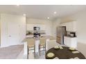 Well-equipped kitchen with granite countertops, stainless steel appliances and island seating at 1433 Dalkeith Cv, Sanford, FL 32771