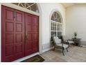 Inviting entryway with double doors, tiled floor, sitting area, and lots of natural light at 14378 Stamford Cir, Orlando, FL 32826