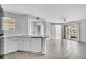 Bright, open-concept living area featuring modern flooring, a ceiling fan, and sliding doors to a patio at 1908 Lake Atriums Cir # 3, Orlando, FL 32839