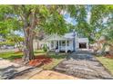 Charming home with a brick driveway, lush lawn, and mature trees at 2114 Gerda Ter, Orlando, FL 32804