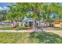 Captivating house with a green lawn and mature trees, offering shade and charm in a peaceful neighborhood at 2114 Gerda Ter, Orlando, FL 32804