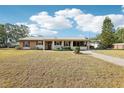 Charming single-story home with a well-maintained lawn, metal roof, and colorful accents at 2314 Falkner Rd, Orlando, FL 32810
