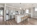 The gourmet kitchen boasts stainless steel appliances, granite countertops, and a large center island with bar seating at 2737 Serenity Meadow Dr, Kissimmee, FL 34744