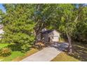A home with a long driveway surrounded by lush greenery and mature trees at 2765 Eldred Ct, Apopka, FL 32712