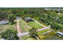 Wide aerial view of property lines, home, and surrounding area near the lake at 2825 Lakeshore Dr, Mount Dora, FL 32757