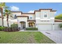 Charming two-story home featuring a tile roof, manicured lawn, and two-car garage at 2860 Falconhill Dr, Apopka, FL 32712