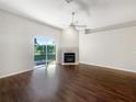 Bright living room featuring a fireplace and sliding glass doors to the backyard at 30442 Pga Dr, Sorrento, FL 32776