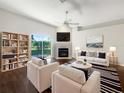 Bright living room featuring a fireplace, modern furnishings, and sliding glass doors to the backyard at 30442 Pga Dr, Sorrento, FL 32776