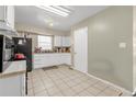 Bright kitchen featuring white cabinets, tiled flooring, ample counter space, and modern black appliances at 4108 Drexel Ave, Orlando, FL 32808
