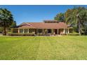 Inviting single-story residence featuring a well-kept lawn, mature landscaping, and brick details at 4464 Willow Wind Ct, Orlando, FL 32835