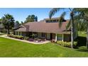 A brick home featuring a well-manicured lawn, vibrant landscaping, and a welcoming brick walkway on a sunny day at 4464 Willow Wind Ct, Orlando, FL 32835