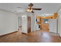 Spacious room with wooden flooring, a ceiling fan, and a kitchen view for easy serving at 4816 Davisson Ave, Orlando, FL 32804