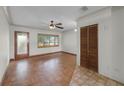 Bright living room boasts hardwood floors, a ceiling fan, and natural light from a large window and glass door at 4816 Davisson Ave, Orlando, FL 32804