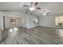 Open-concept living room with neutral walls, wood-look floors, and plenty of natural light at 5037 Bermuda Cir # 10, Orlando, FL 32808