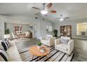 Bright living room featuring modern furniture, a ceiling fan, and wood-look floors at 5037 Bermuda Cir # 10, Orlando, FL 32808
