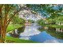 Scenic community pond view with fountain surrounded by lush greenery and buildings at 5468 E Michigan E St # 4, Orlando, FL 32812