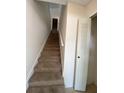 Carpeted staircase leading upstairs, with a large closet nearby at 5468 E Michigan E St # 4, Orlando, FL 32812