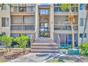 A ground-level entrance with stairs leading to upper-level units in a well-maintained building at 574 Orange Dr # 78, Altamonte Springs, FL 32701