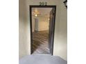 Front door showing luxury vinyl plank flooring and a view into the condo unit at 627 Dory Ln # 202, Altamonte Springs, FL 32714