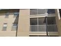 Exterior shot of condo building with light pole, screened balconies, and neutral color scheme at 627 Dory Ln # 202, Altamonte Springs, FL 32714