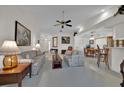 Bright and airy living room with tile flooring, ceiling fan, and plenty of space for relaxing at 633 Watercrest Dr, Haines City, FL 33844