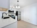 Bright kitchen with stainless steel appliances, modern countertops, and sleek white cabinetry at 6508 Coral Cove Dr, Orlando, FL 32818